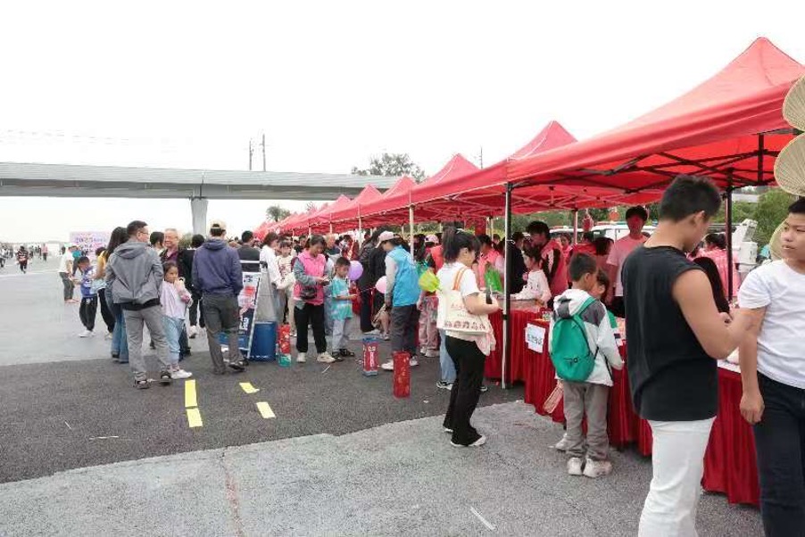 Visitors walking through the Xixiang charity bazaar