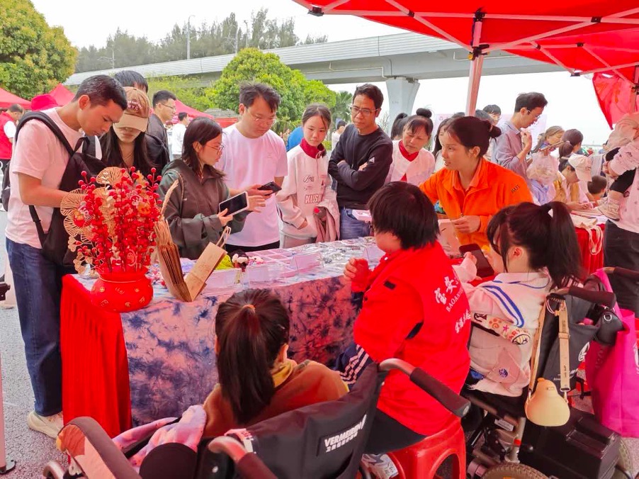 Community members gathering around a charitable activity booth at the event